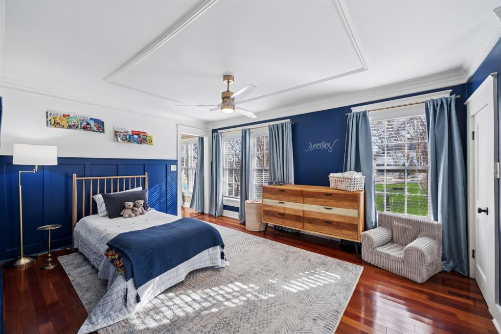 704 Williams Street Rockwall, TX 75087 - Photo 25 of 39 a bedroom with a bed and wooden floor