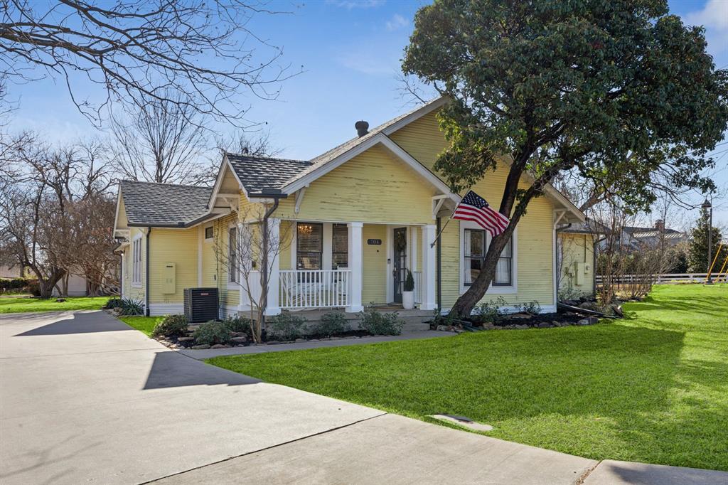 704 Williams Street Rockwall, TX 75087 - Photo 3 of 39 a front view of a house with a yard and trees