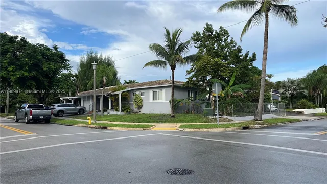 a view of street with palm trees