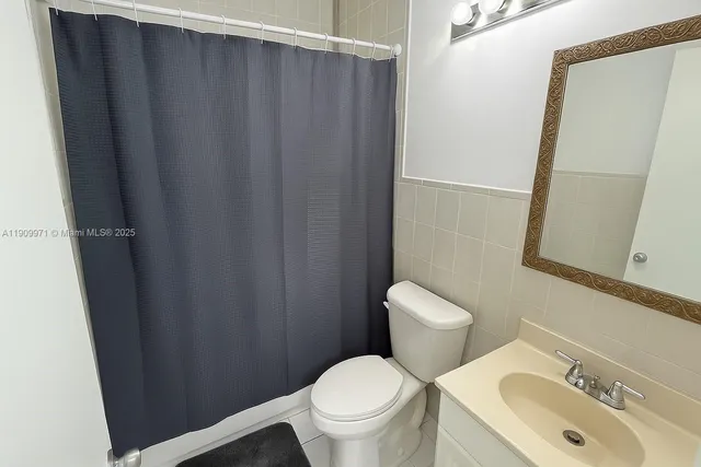 a white toilet sitting next to a bathroom sink