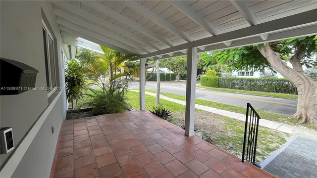 a view of a porch with furniture and garden