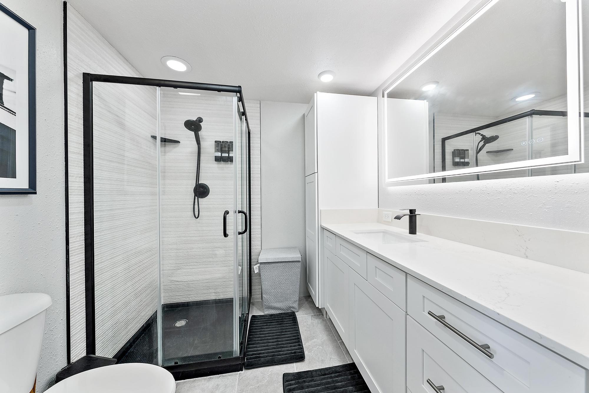 a bathroom with a shower sink and toilet