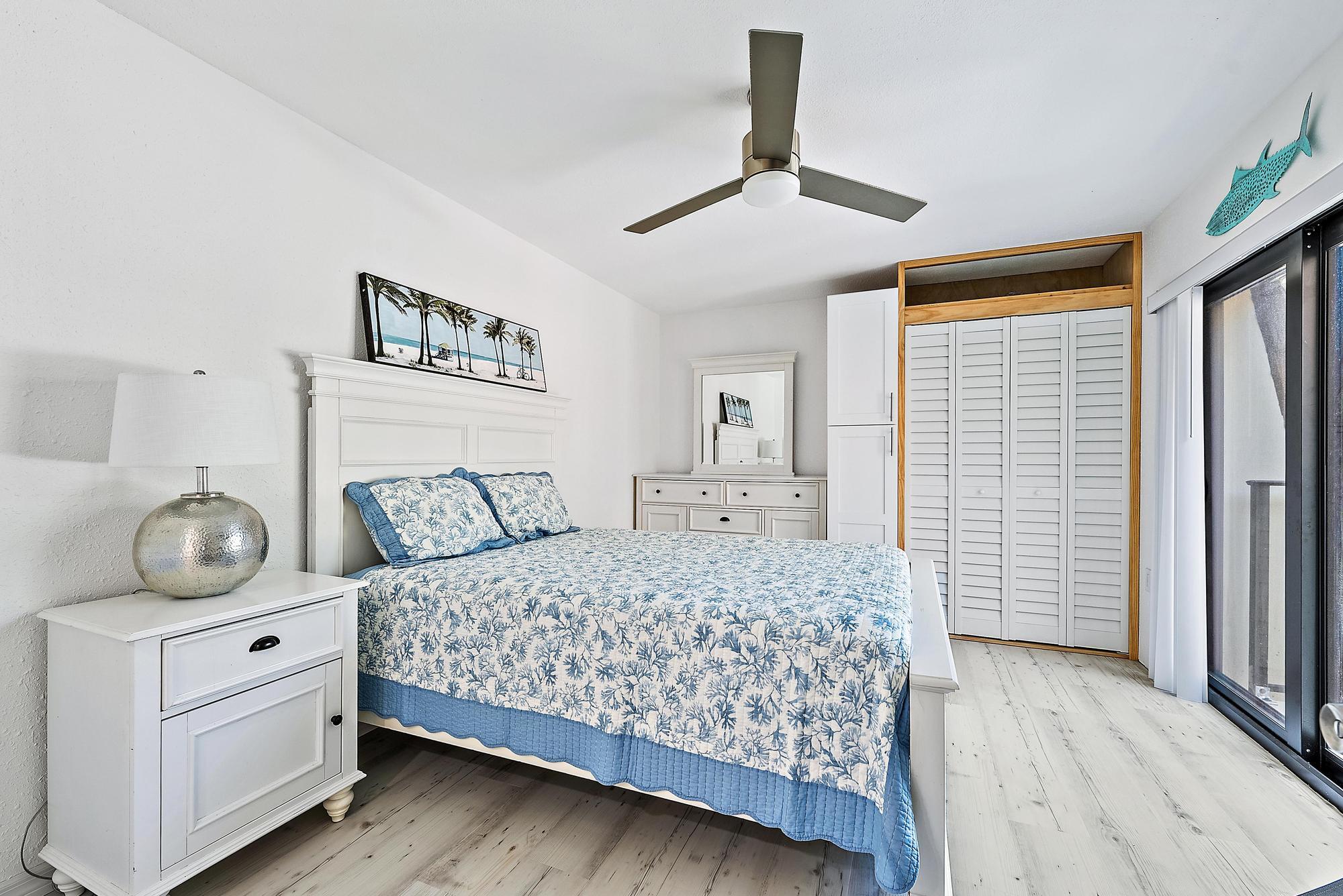 2902 29th Court Jupiter, FL 33477 - Photo 16 of 24 a bedroom with a bed and wooden floor