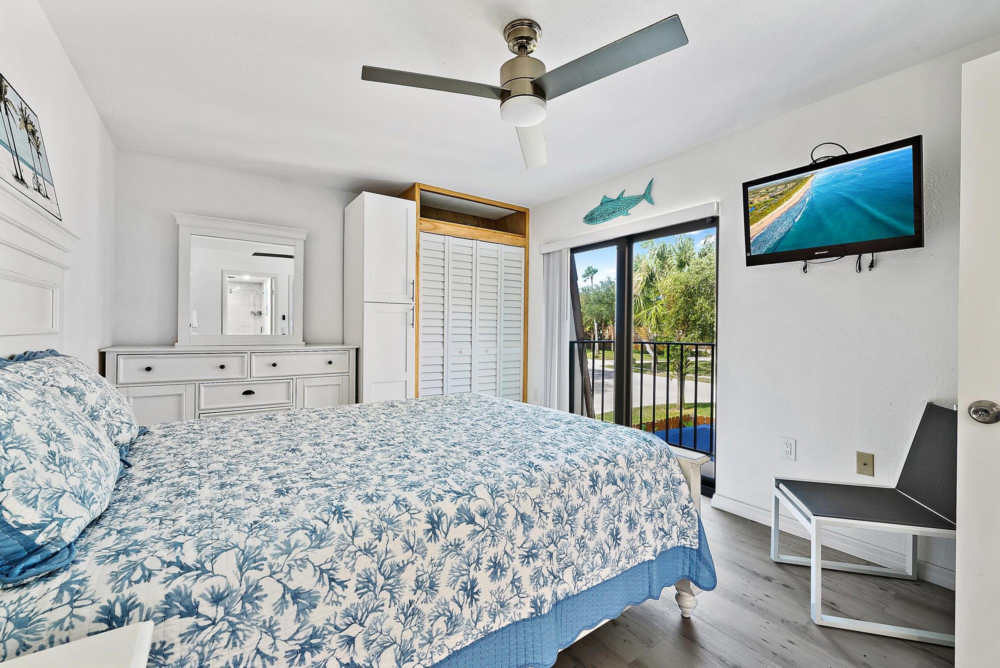 2902 29th Court Jupiter, FL 33477 - Photo 17 of 24 a bedroom with a large bed and a chair