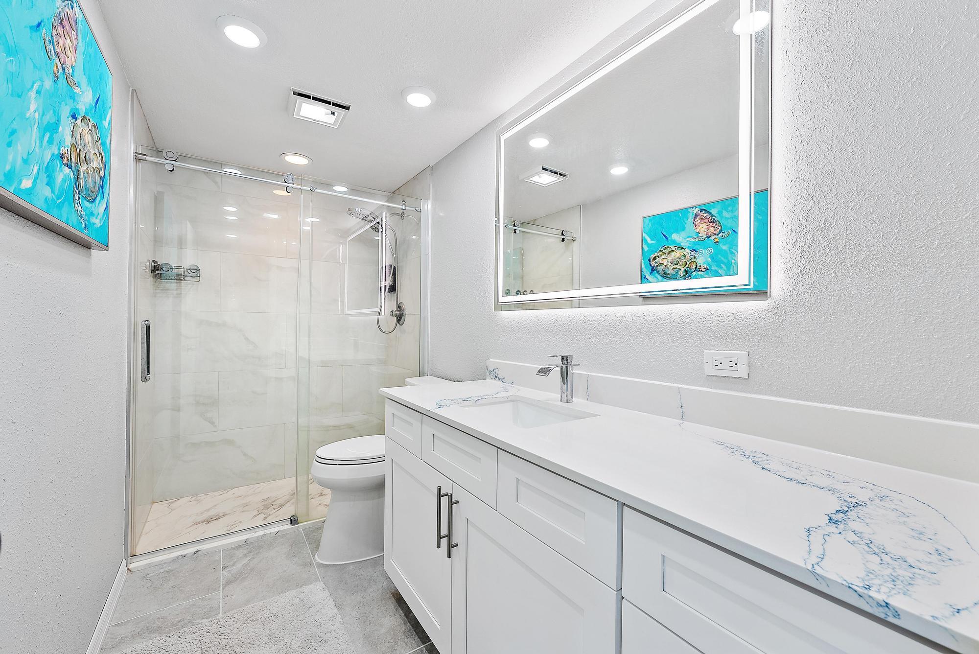 2902 29th Court Jupiter, FL 33477 - Photo 18 of 24 a bathroom with a sink a toilet and shower