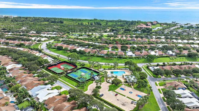 an aerial view of residential houses with outdoor space