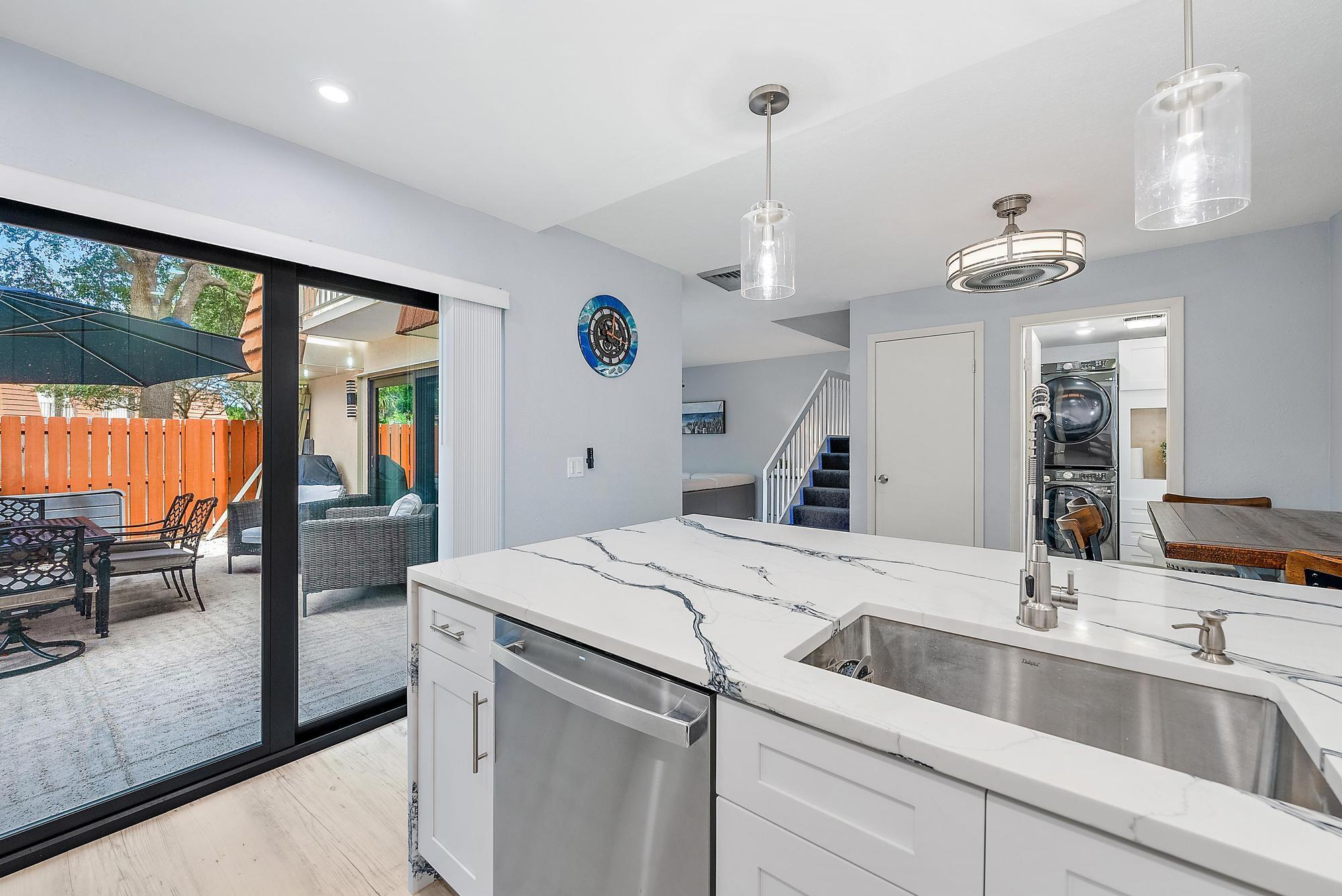 2902 29th Court Jupiter, FL 33477 - Photo 5 of 24 a kitchen with a sink and a refrigerator