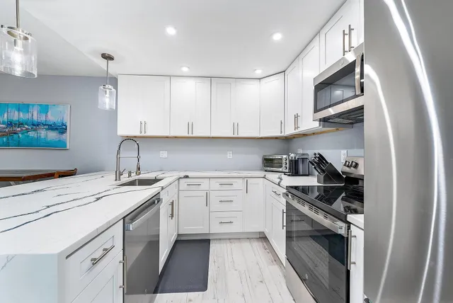 a kitchen with a sink stove and cabinets