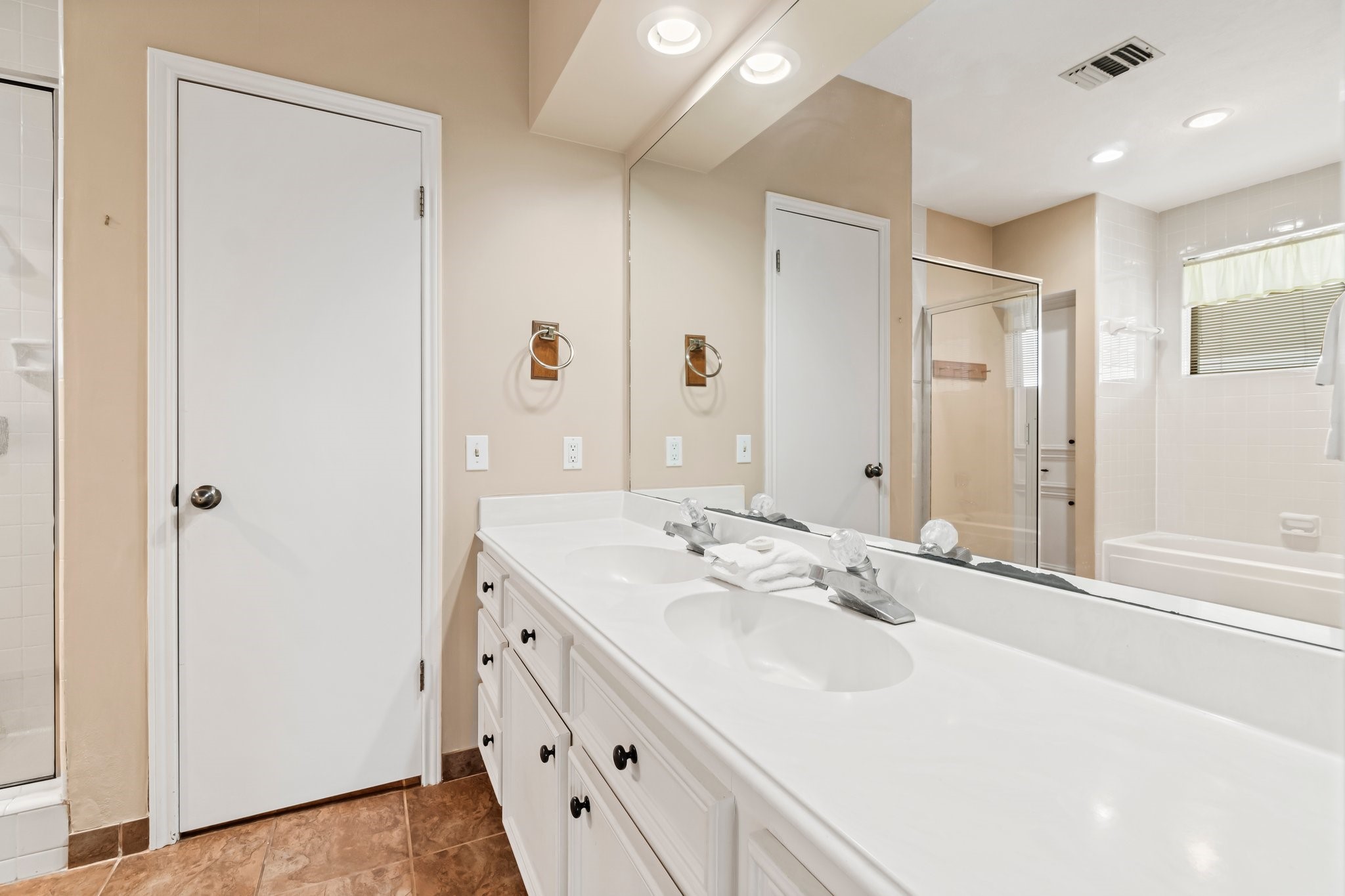 2839 Hemingway Drive Montgomery, TX 77356 - Photo 28 of 49 This bathroom features a spacious double vanity with ample counter space and storage, a large mirror, and modern lighting. It includes a separate shower and bathtub, offering a clean and functional layout.