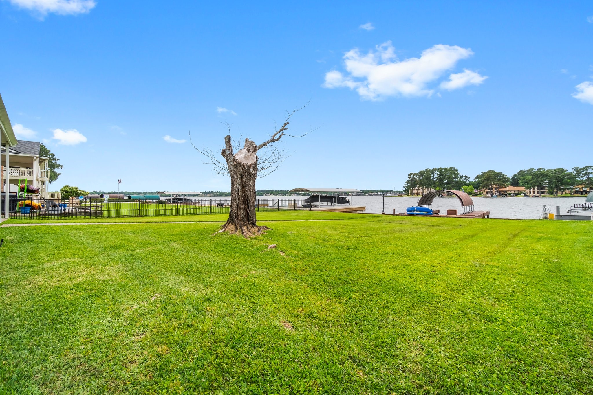 2839 Hemingway Drive Montgomery, TX 77356 - Photo 35 of 49 Spacious waterfront property with a lush green lawn and a picturesque view of the lake. Includes a private dock and boat slip, perfect for lakeside living.