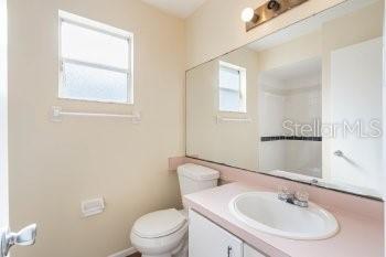 1032 Inkberry Court Orlando, FL 32811 - Photo 12 of 16 a bathroom with a sink a toilet and a mirror
