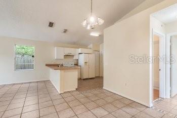 1032 Inkberry Court Orlando, FL 32811 - Photo 3 of 16 a view of a kitchen with a sink dishwasher and a refrigerator