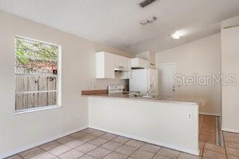 1032 Inkberry Court Orlando, FL 32811 - Photo 4 of 16 a kitchen with stainless steel appliances granite countertop a sink and a granite counter tops