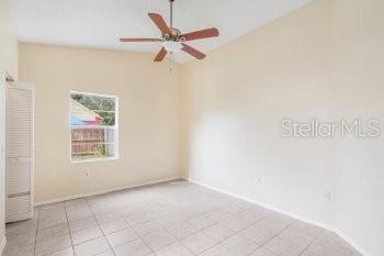 1032 Inkberry Court Orlando, FL 32811 - Photo 9 of 16 an empty room with a window and a fan