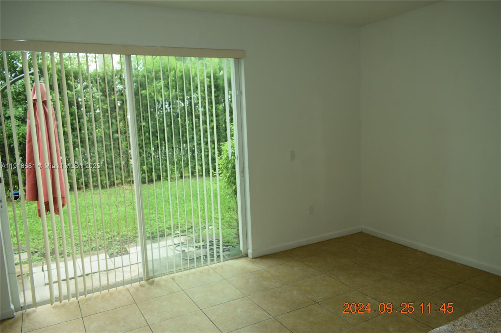 12080 Southwest 268th Street, Unit 28 Homestead, FL 33032 - Photo 13 of 25 a view of a back yard from a window