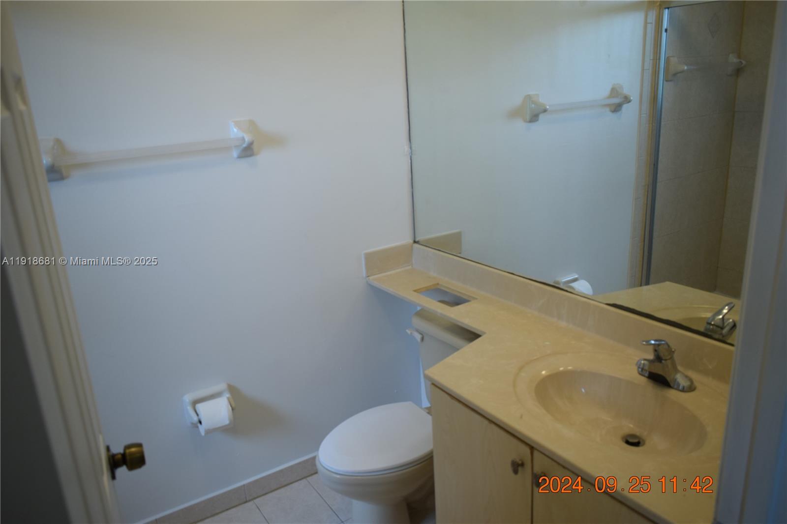 12080 Southwest 268th Street, Unit 28 Homestead, FL 33032 - Photo 14 of 25 a bathroom with a sink toilet and vanity