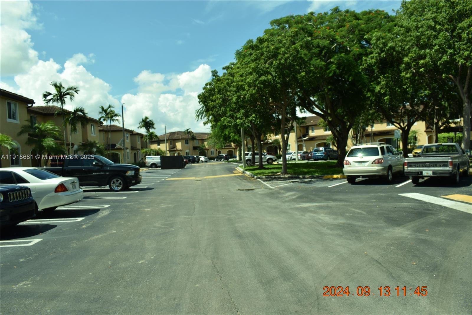 12080 Southwest 268th Street, Unit 28 Homestead, FL 33032 - Photo 19 of 25 a view of a parked cars in front of a building