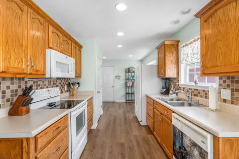 a kitchen with a sink a stove and cabinets