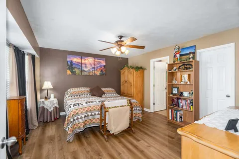 a bedroom with bed and a chandelier