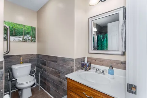 a bathroom with a sink toilet and mirror