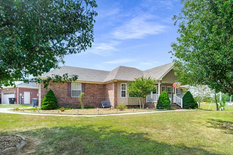 a front view of house with yard and green space