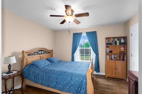 a bedroom with a bed and a book shelf