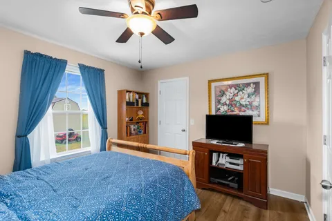 a bedroom with furniture and a flat screen tv