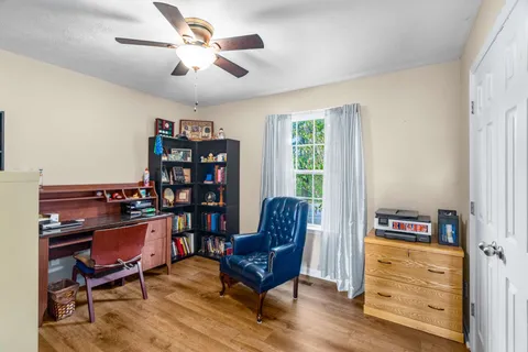 a living room with furniture and a bookshelf