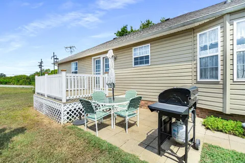 a view of a chairs and table in patio