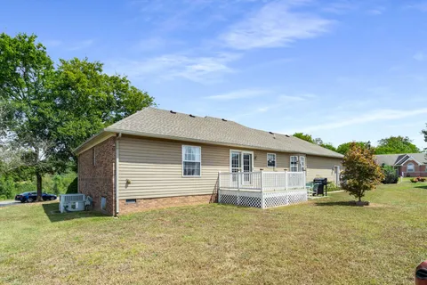 a white house that has a tree in front of it