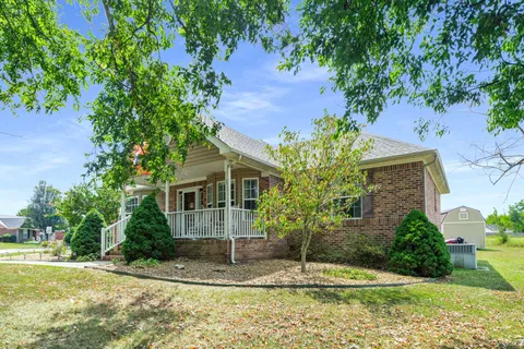 a front view of a house with a yard garage and outdoor seating