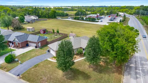 an aerial view of a house with a garden and lake view