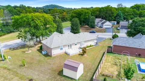 an aerial view of a house with pool
