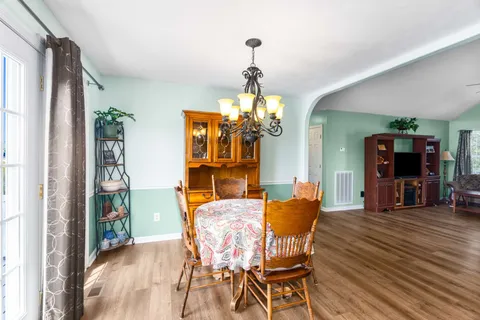 a dining room with furniture and window