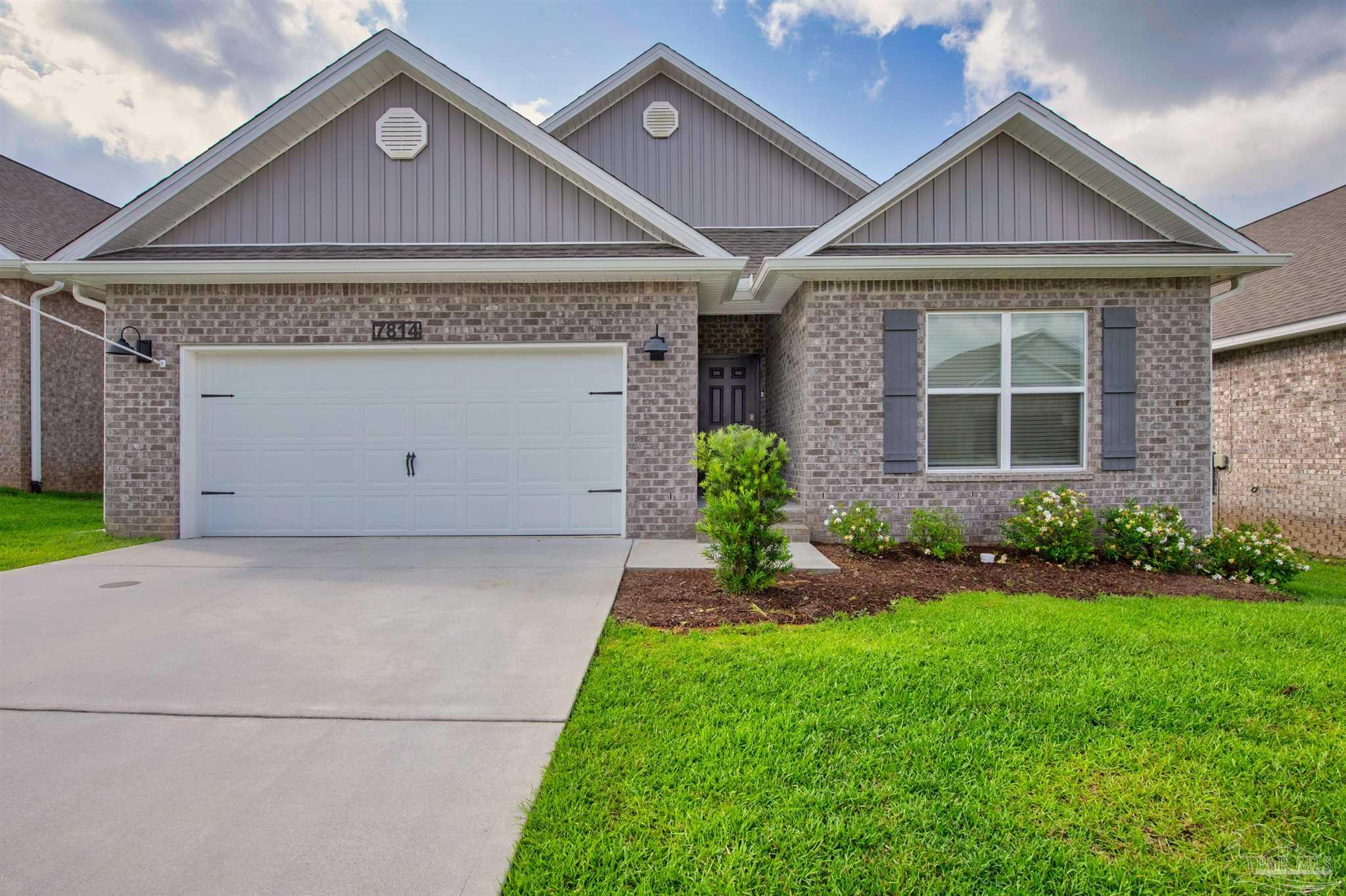 7814 Burnside Loop Pensacola, FL 32526 - Photo 1 of 41 a front view of a house with a garden and plants