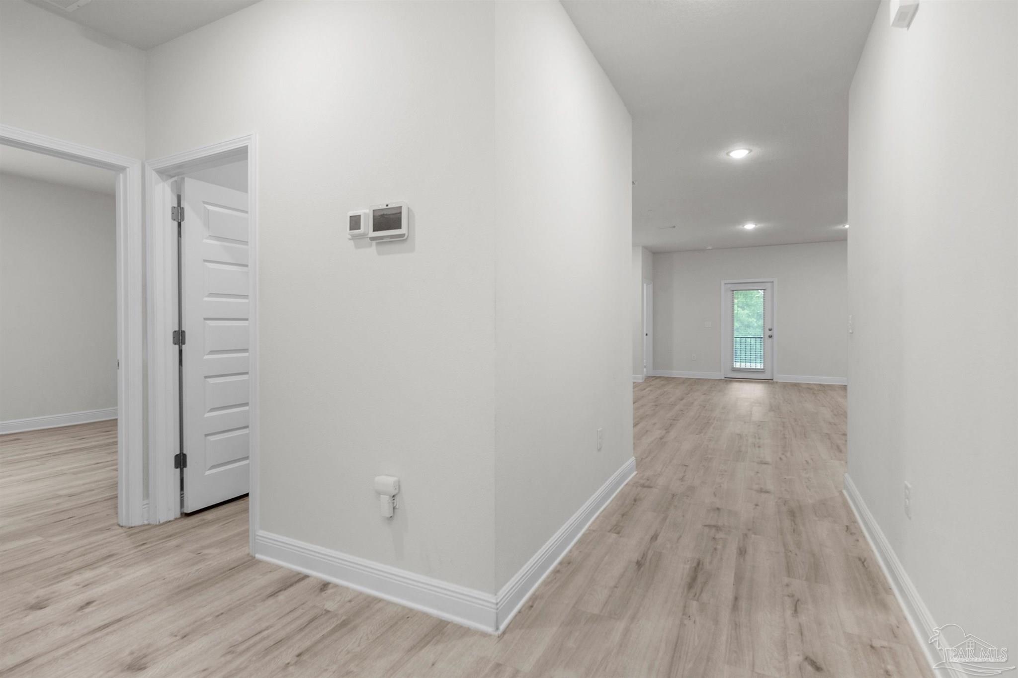 7814 Burnside Loop Pensacola, FL 32526 - Photo 12 of 41 wooden floor in an empty room with a window