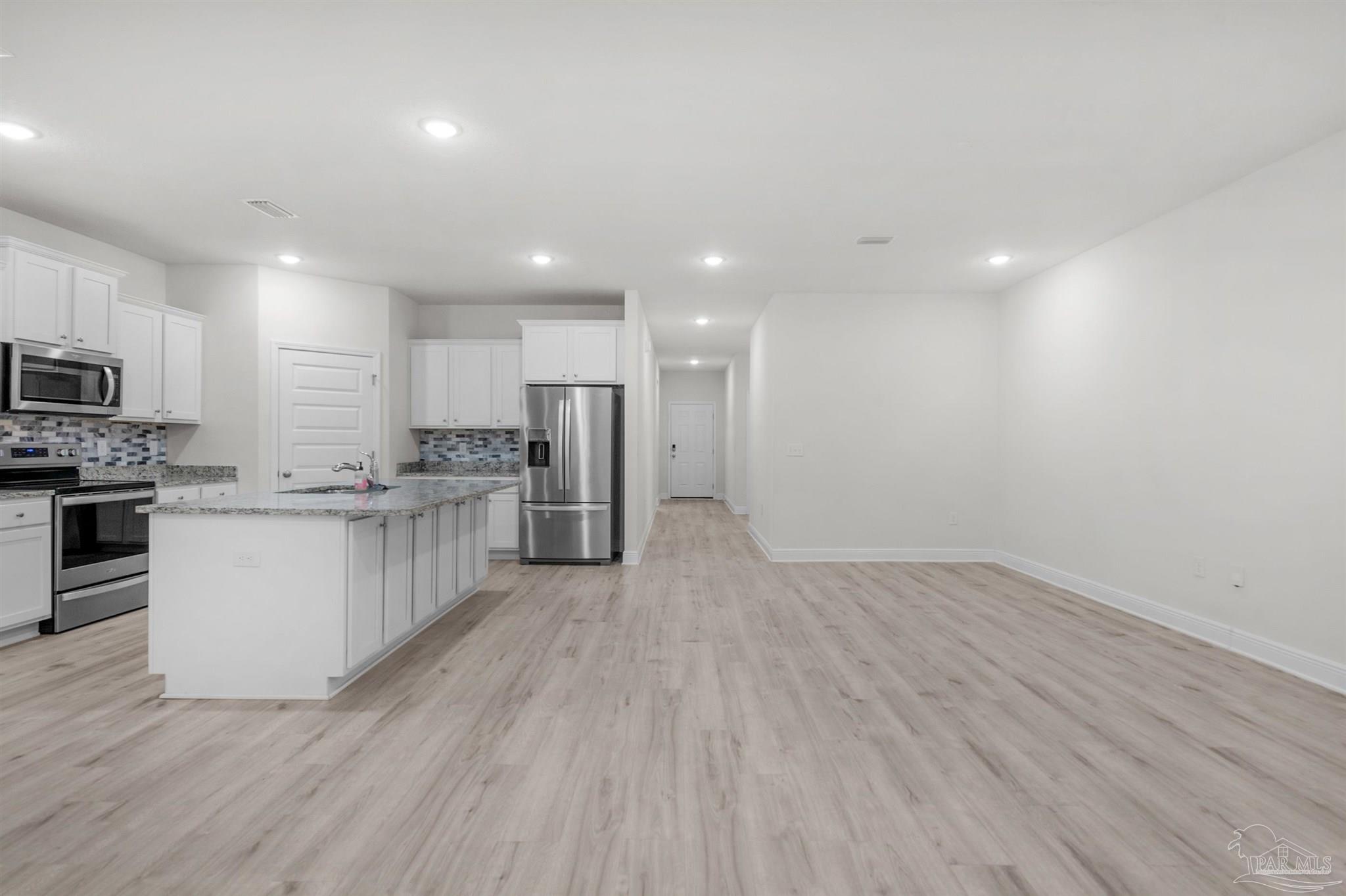 7814 Burnside Loop Pensacola, FL 32526 - Photo 18 of 41 a view of kitchen with granite countertop cabinets and refrigerator