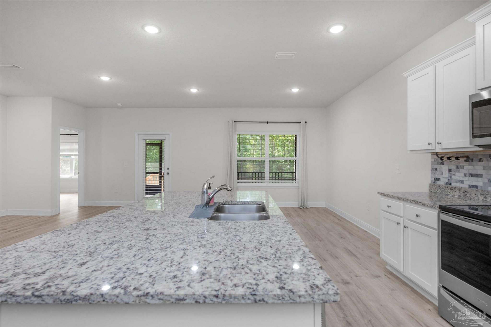 7814 Burnside Loop Pensacola, FL 32526 - Photo 23 of 41 a large kitchen with sink in it