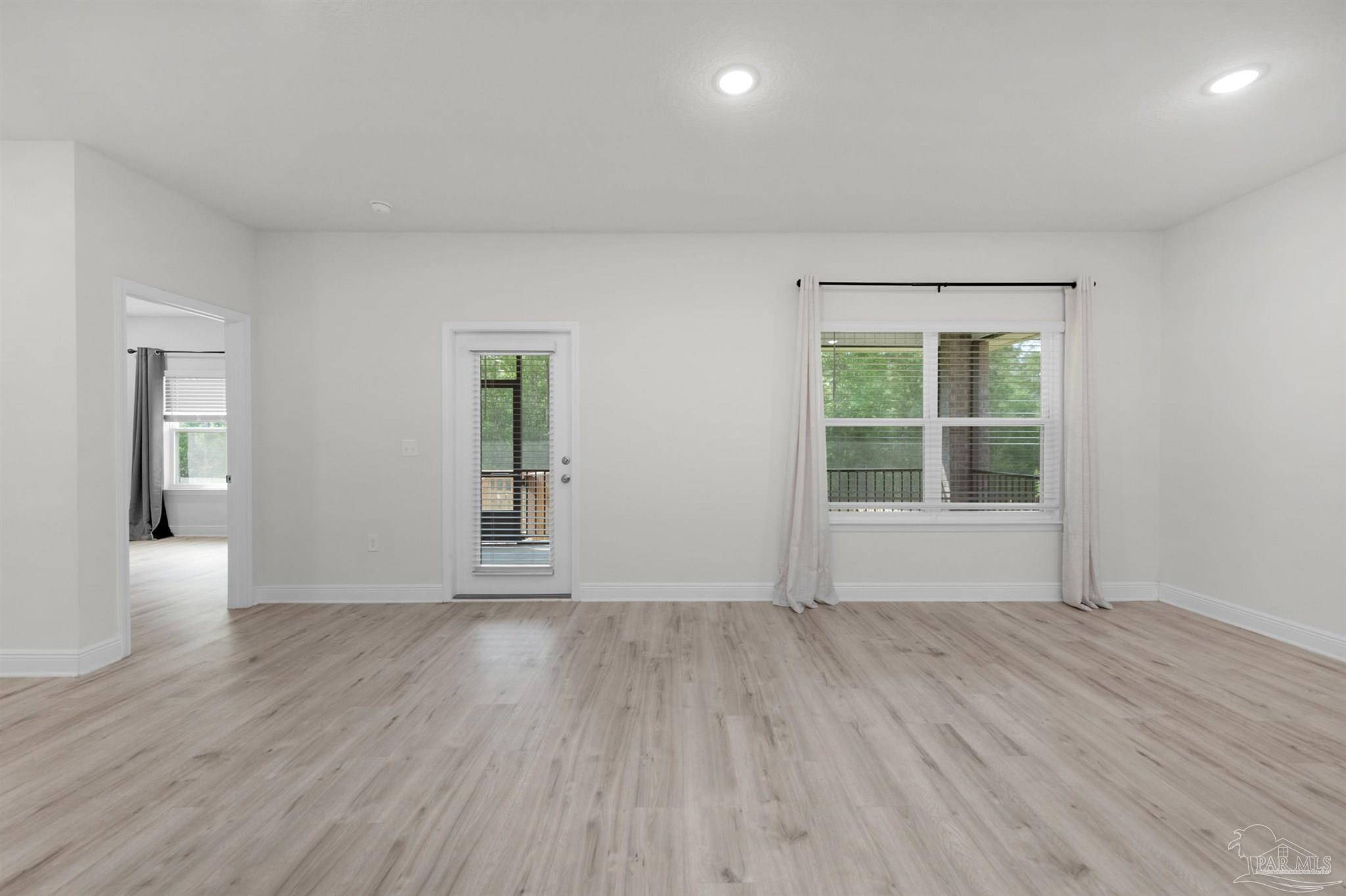 7814 Burnside Loop Pensacola, FL 32526 - Photo 25 of 41 wooden floor in an empty room with a window
