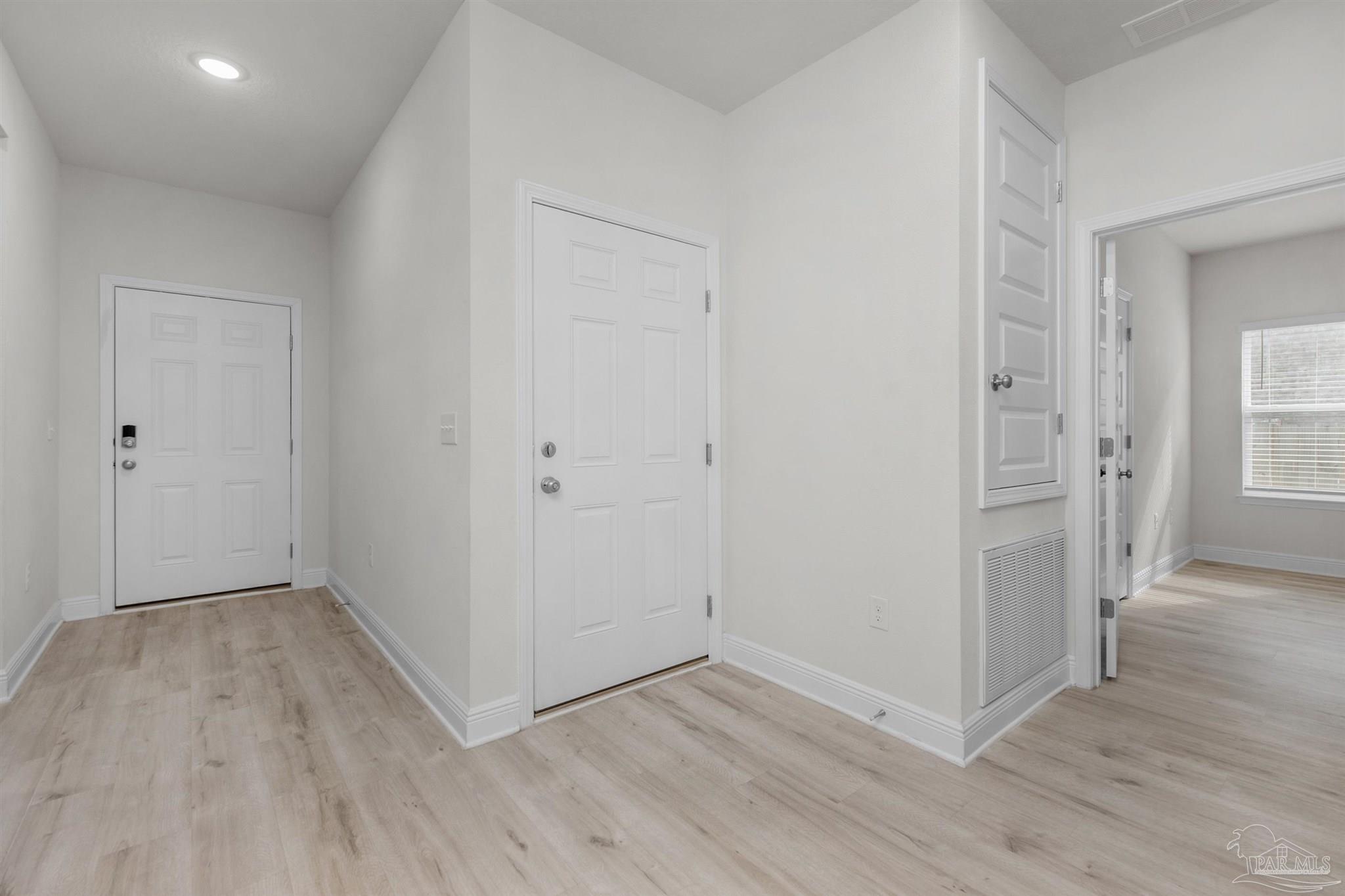 7814 Burnside Loop Pensacola, FL 32526 - Photo 5 of 41 wooden floor & wooden door in an empty room