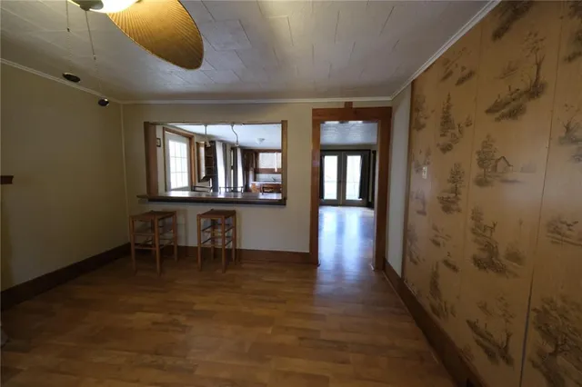 a view of a room with wooden floor and chandelier