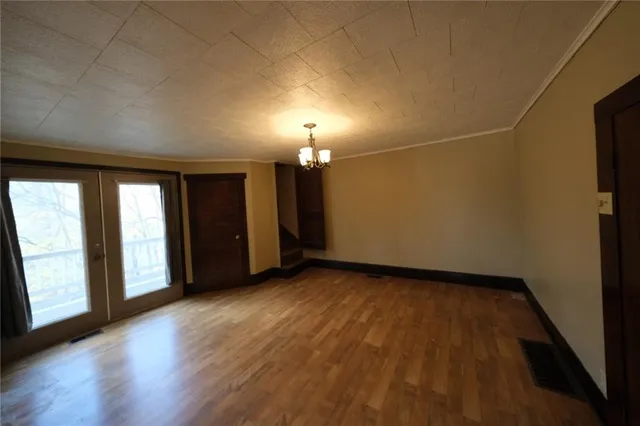 an empty room with windows and closet