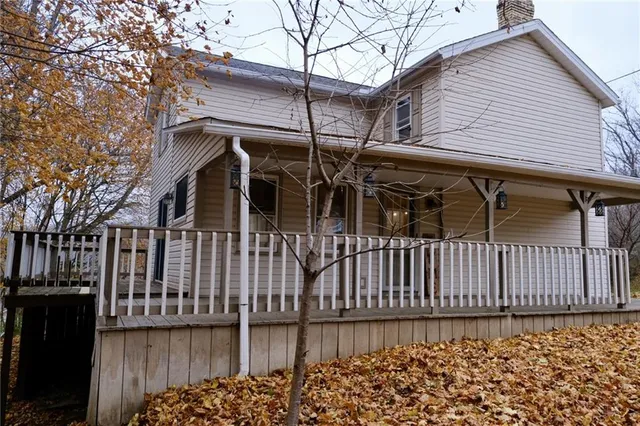 a view of a house with wooden fence