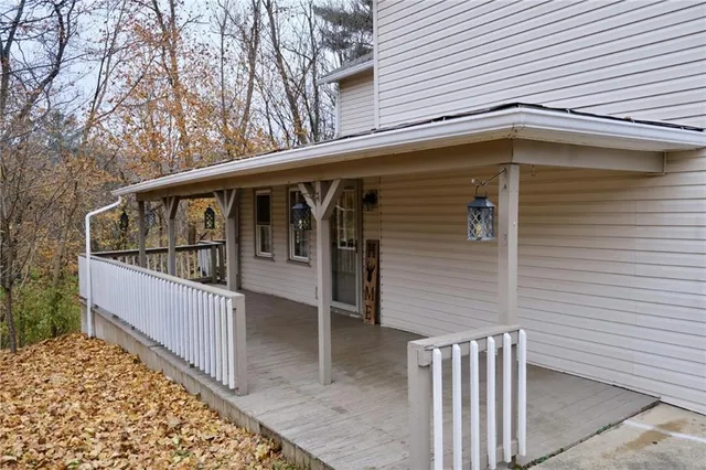a view of a house with wooden fence