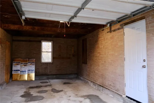 a kitchen with wooden floors and black appliances