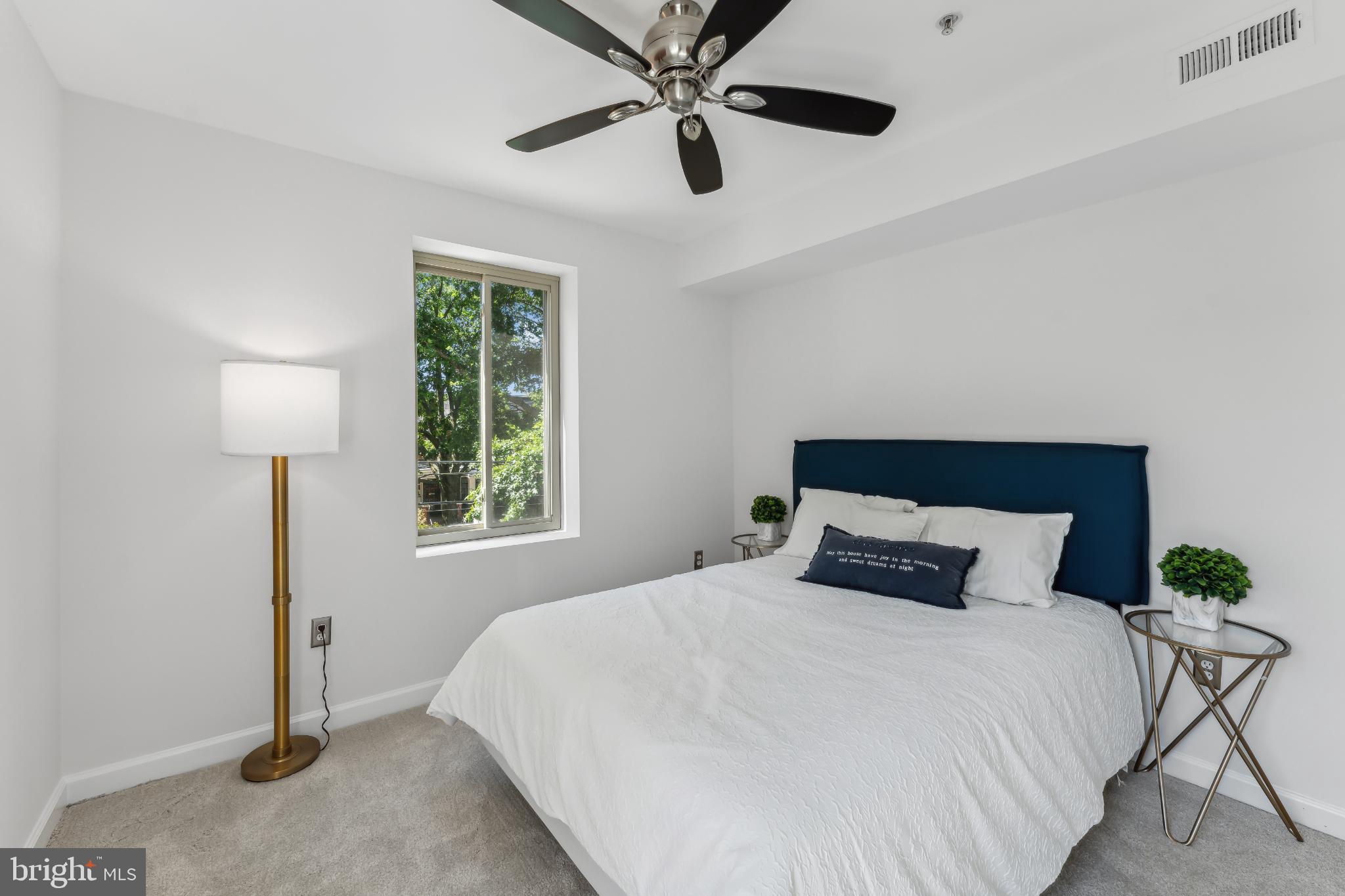 5403 9th Street Northwest, Unit 204 Washington, DC 20011 - Photo 15 of 19 a bedroom with a bed and a window