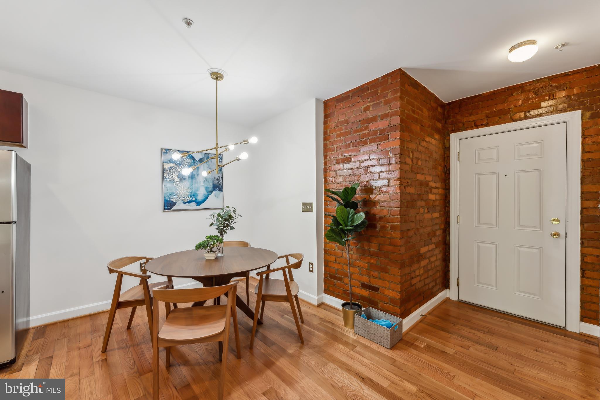 5403 9th Street Northwest, Unit 204 Washington, DC 20011 - Photo 5 of 19 a dining room with furniture and wooden floor
