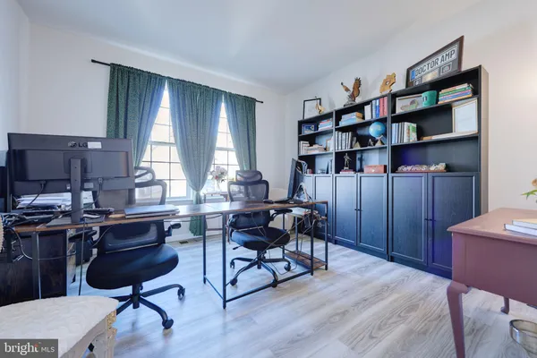 a view of a workspace with furniture and a bookshelf