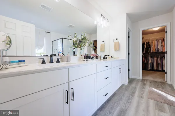 a spacious bathroom with a double vanity sink double and mirror