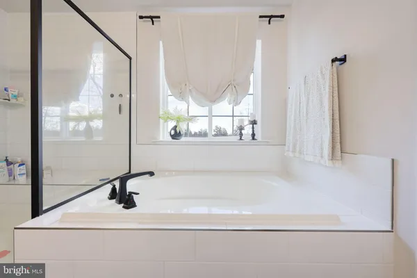 a bathroom with a window sink and mirror